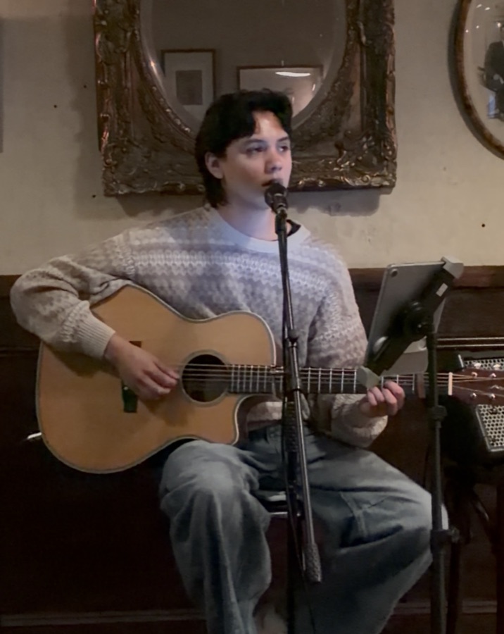 Liam performing an acoustic set at Mr Watkins