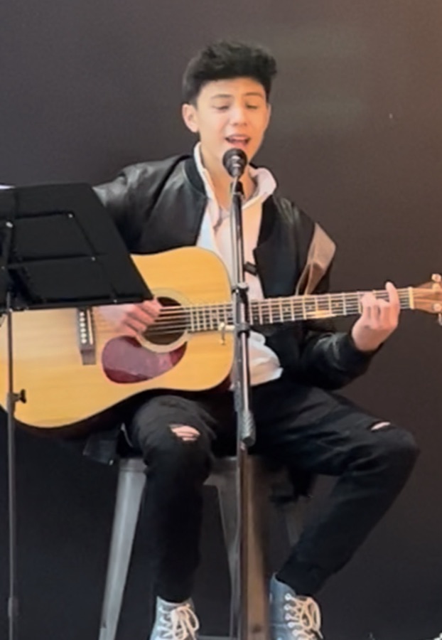 Liam performing live acoustic music at the Westfield rooftop dining district